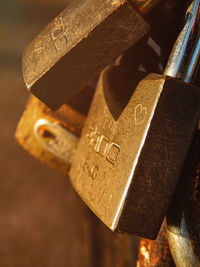 Close-up of padlocks hanging on rusty metal