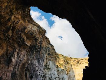 Low angle view of rock formation against sky