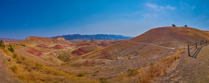 Scenic view of mountains against clear blue sky