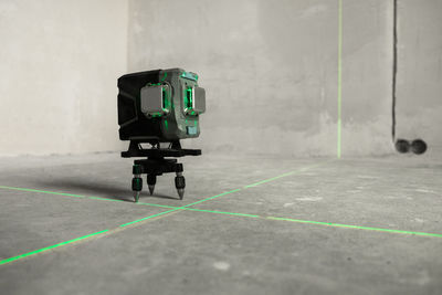 Laser level, construction, finishing work in the room. laser building level with green beams 