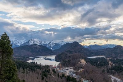 Scenic view of river and mountains against sky