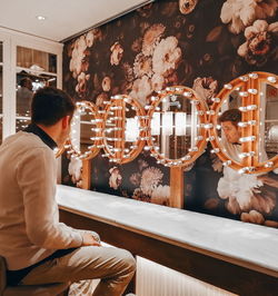 Man looking at his reflection in bathroom