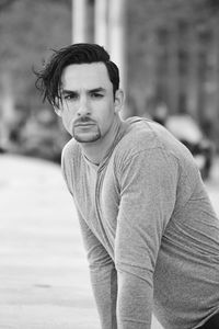 Portrait of handsome man leaning on retaining wall