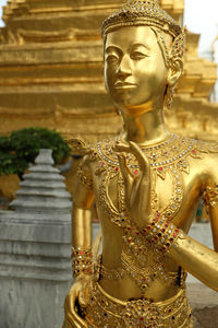 Statue of buddha against building