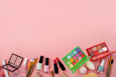 High angle view of christmas decorations on pink background