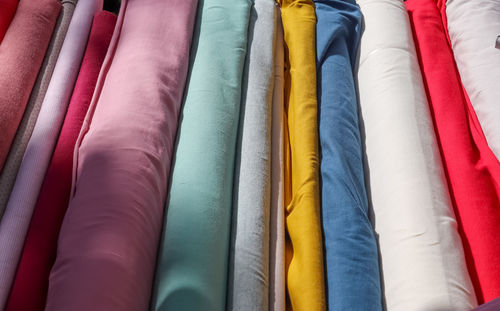 Samples of cloth and fabrics in different colors found at a fabrics market.