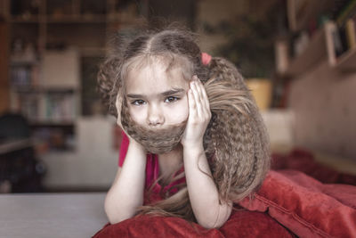 Portrait of girl sitting at home