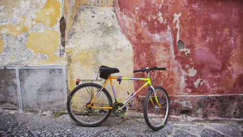 Bicycle parked against wall