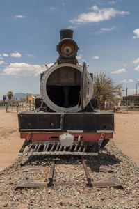 Abandoned train on railroad track against sky