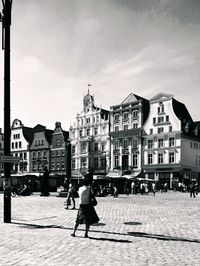 People walking in front of building