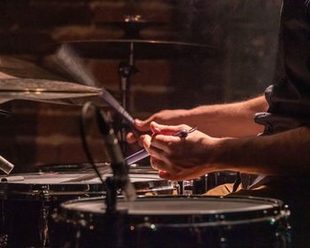 Midsection of man playing piano