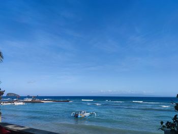 Scenic view of sea against blue sky