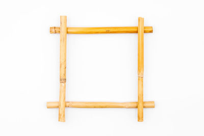 Directly above shot of wooden chair against white background