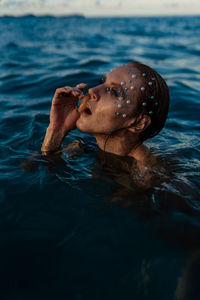 Side view of woman swimming in sea