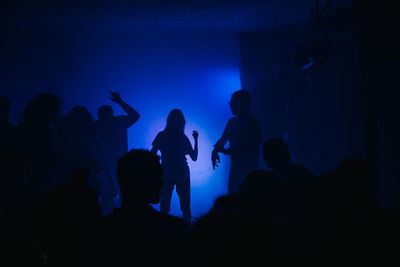 Silhouette people dancing at nightclub