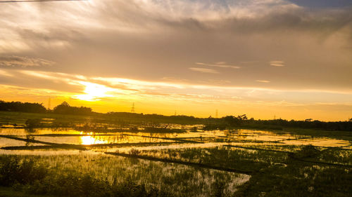 Scenic view of lake against sky during sunset