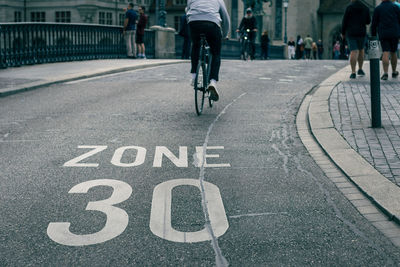 Speed limit sign on street, bicycle on road at area of zone 30 speed limit