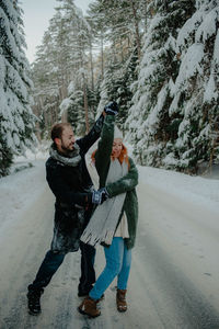 People on snow covered tree during winter