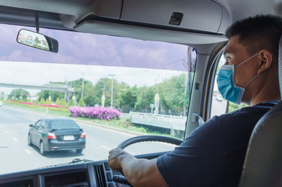 Man seen through car window