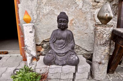 Statue of buddha against building