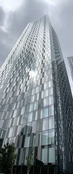 Low angle view of modern glass building against sky