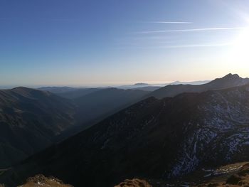 Scenic view of mountains against clear sky during sunset