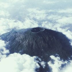 Scenic view of mountains against cloudy sky