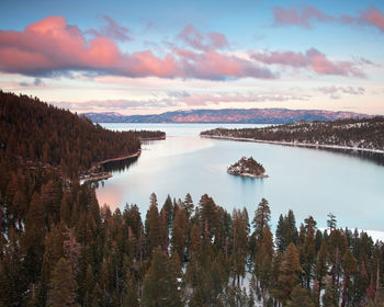 Scenic view of river and mountains against sky