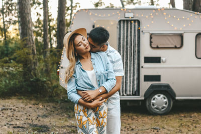 Married asian couple in love travel by camper car on a road trip in nature on their honeymoon