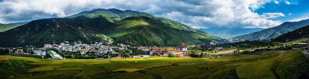 Panoramic view of houses and mountains against sky