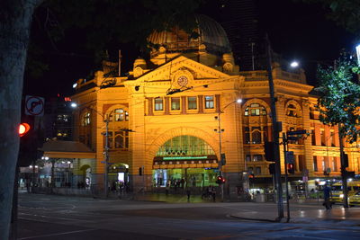 Statue in city at night