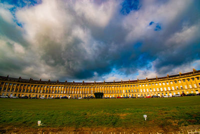 Panoramic view of buildings against cloudy sky