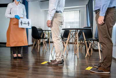 Low angle view of male and woman walking on floor