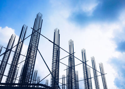 Low angle view of construction site against cloudy sky