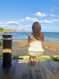 Rear view of woman looking at sea against sky mistero sensual  relaxation 