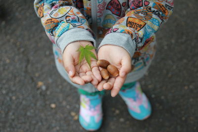 Low section of child holding hands