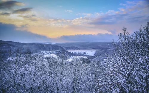 Snow covered landscape against sky