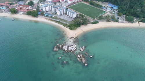 High angle view of sea by city