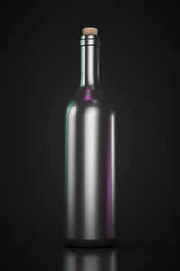 Close-up of empty glass bottle against black background