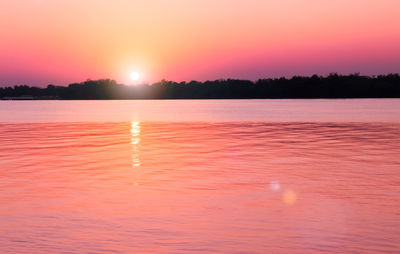 Scenic view of sea against romantic sky at sunset