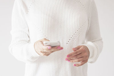 Midsection of woman using mobile phone