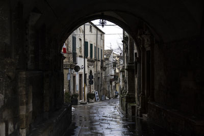 Narrow alley amidst old buildings in city
