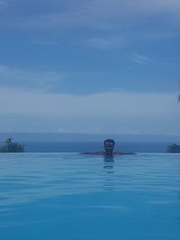 Portrait of young man swimming in pool