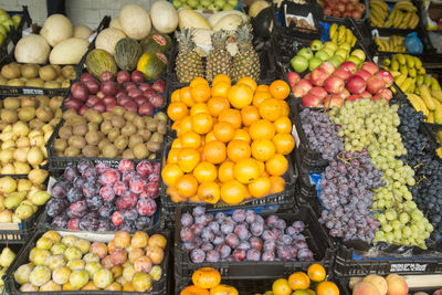 Various fruits in crates for sale at market stall