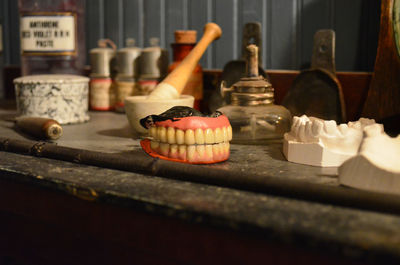 Dentures and objects on table at museum