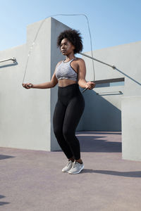 African american female athlete jumping with rope