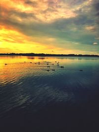 Scenic view of lake against sky at sunset