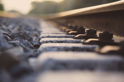 Surface level of railroad track during sunset