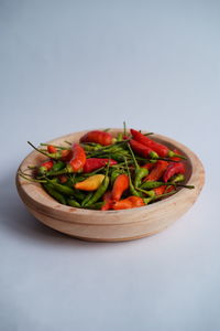 Close-up of vegetables in bowl against white background