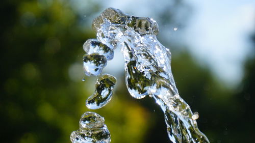 Close-up of water drop falling on ice